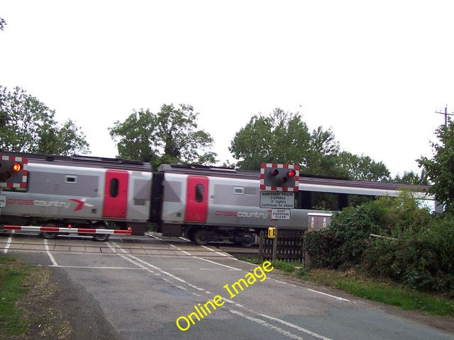 Photo 6x4 Train going through level crossing Dunhampstead  c2010